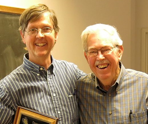 Dr. Michael R. Strand, University of Georgia with Dr. Ted Hopkins congratulations him.