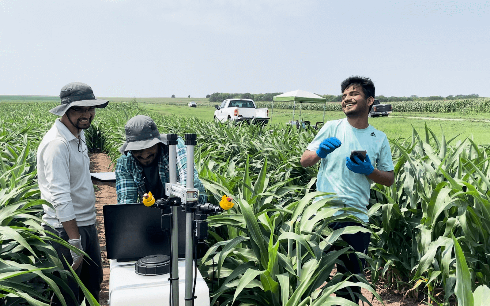 Students in the field with pesticide robot.