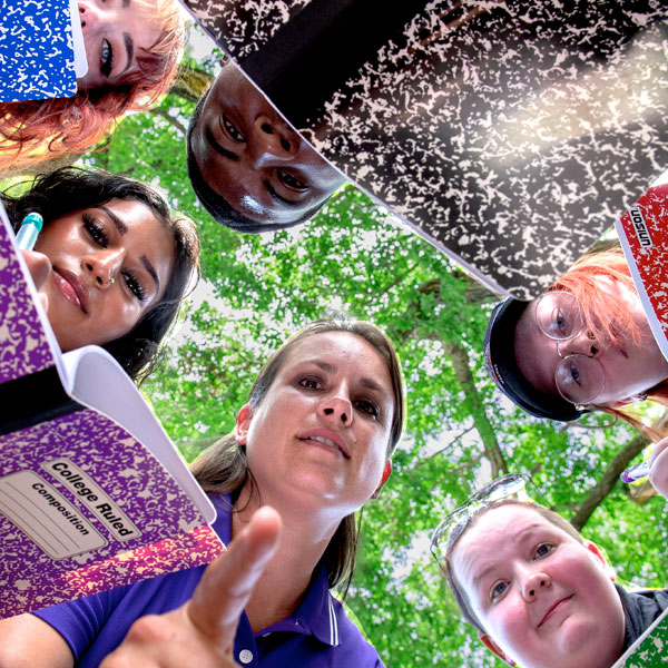 instructor and students studying a bug